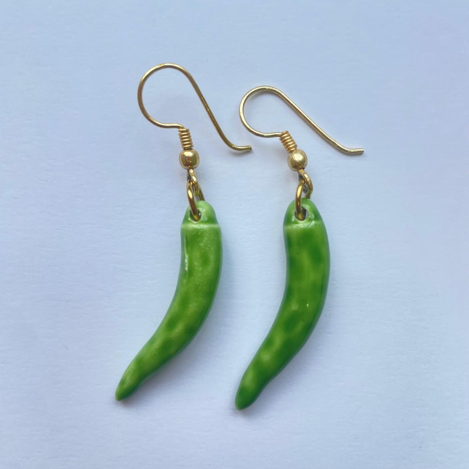 Pendientes de cerámica hechos a mano. El clásico cuerno napolitano es de color verde y su gancho de latón de Marardi